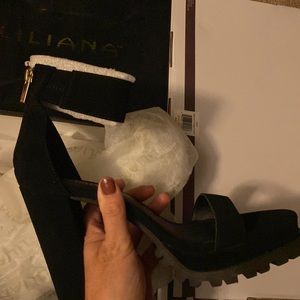 Black wedge heels with an ankle strap gold zip back and open toe